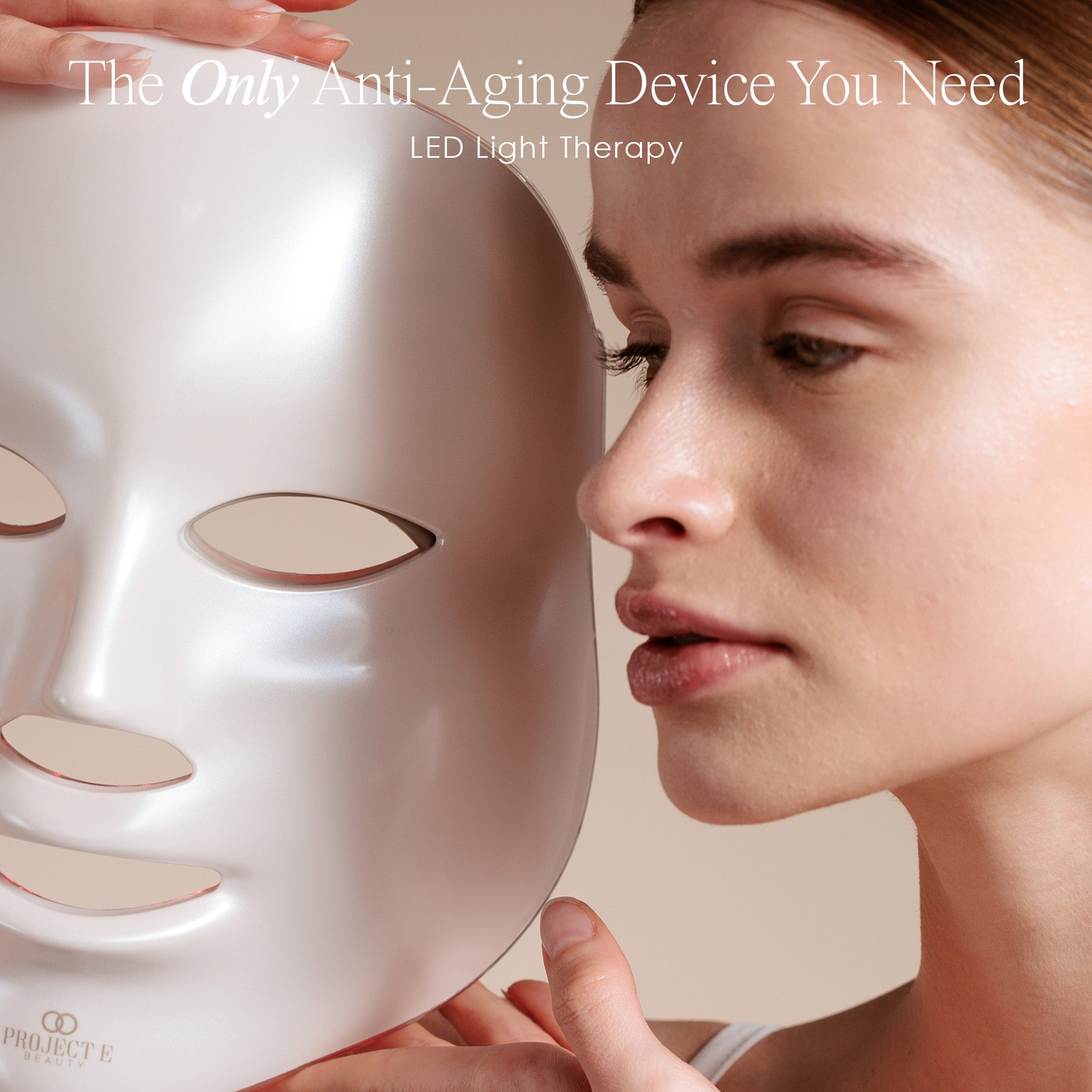 LightAura LED face mask showing a model holding the mask